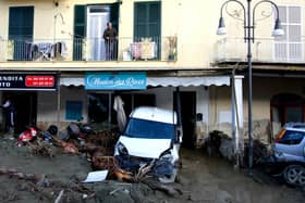 A man looks out from the balcony of his home in Casamicciola on November 27, 2022, following heavy rains that caused a landslide on the island of Ischia, southern Italy. - Italian rescuers were searching for a dozen missing people on the southern island of Ischia after a landslide killed at least one person, as the government scheduled an emergency meeting. A wave of mud and debris swept through the small town of Casamicciola Terme early Saturday morning, engulfing at least one house and sweeping cars down to the sea, local media and emergency services said. (Photo by Eliano IMPERATO / AFP) (Photo by ELIANO IMPERATO/AFP via Getty Images)
