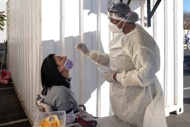 A woman receives a nasal swab, from a health worker wearing personal protective equipment (PPE), to be tested for COVID-19 at the Fourways Life Hospital in Johannesburg (Getty Images)