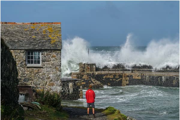 National Trust ranger Seth Jackson looks on as large waves caused by Storm Ellen strike Cornwall in 2020 (Photo by Hugh R Hastings/Getty Images)