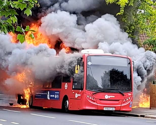 Fire rages through bus as 30 firefighters tackle blaze.