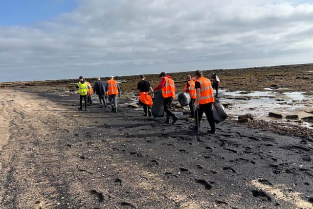 Offenders carrying out Community Payback clear waste from East-Sea Sands.