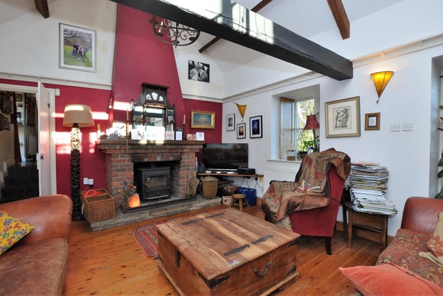 A sitting room with wooden flooring within the property.