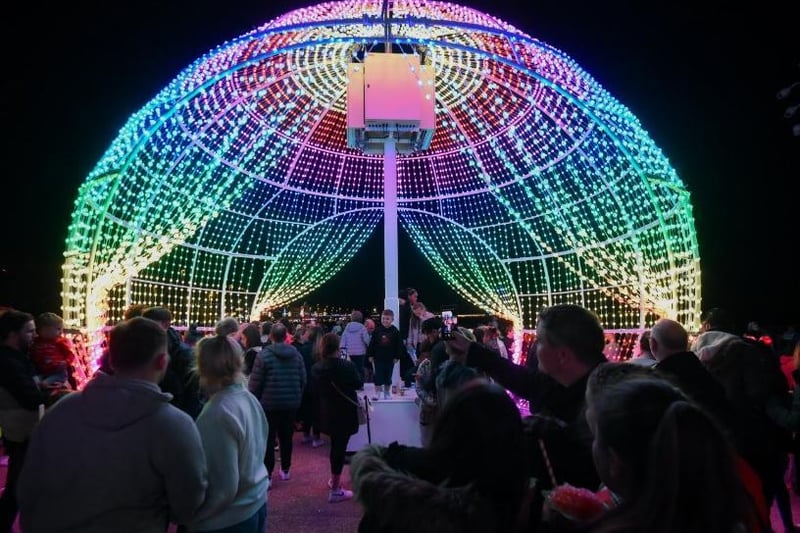 Guests enjoy the night under a curtain of rainbow-coloured lights
