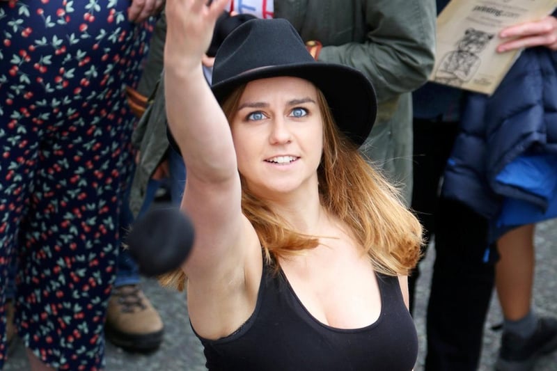 A woman in the crowd attempts to throw a black pudding. The tradition dates back to the War of the Roses and a 1455 battle in Stubbins, Lancashire.