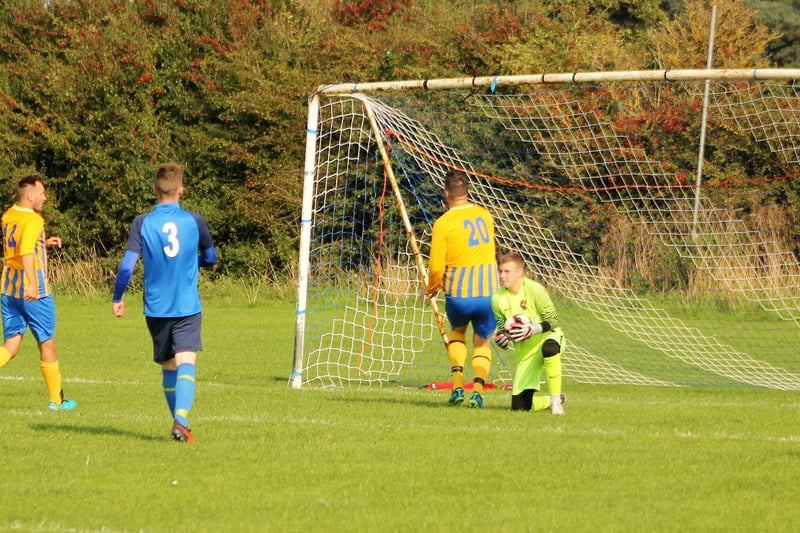 Keeper Alex Chapman collects under pressure from Danny Price