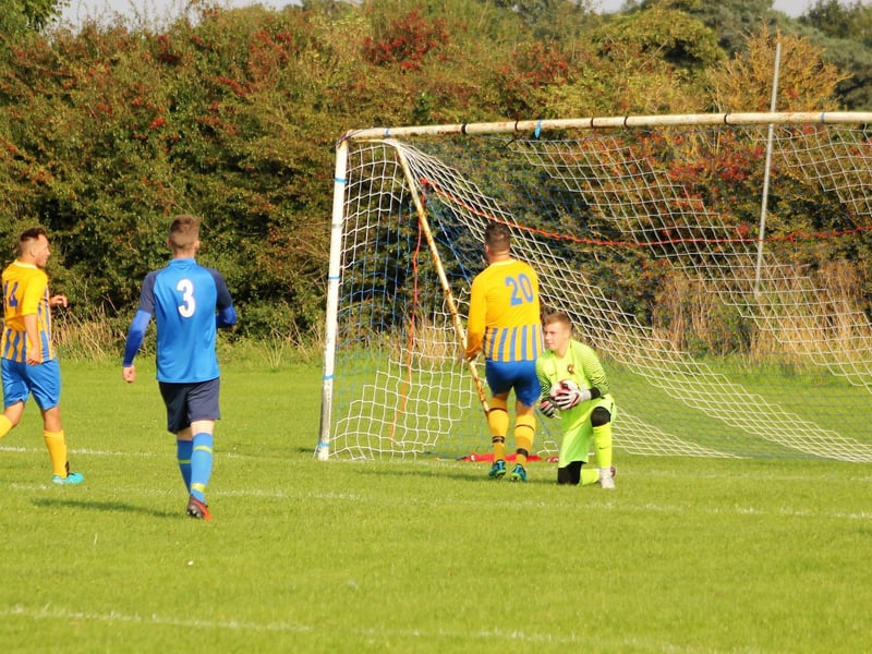 Keeper Alex Chapman collects under pressure from Danny Price