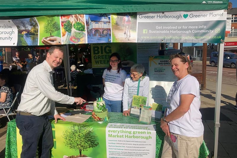 Neil O'Brien MP cuts the Sustainable Harborough green cake during the volunteers fair on Saturday.