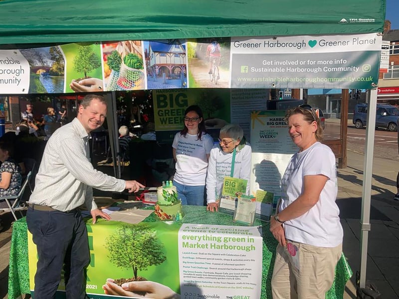 Neil O'Brien MP cuts the Sustainable Harborough green cake during the volunteers fair on Saturday.