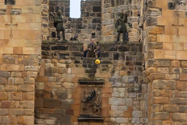 The Duke of Northumberland throws the match ball from the Alnwick Castle Barbican.