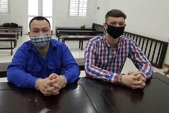 Nguyen Duc Manh and Andrew Eachan Alexander at their trial. Picture:  Hanoi Police.