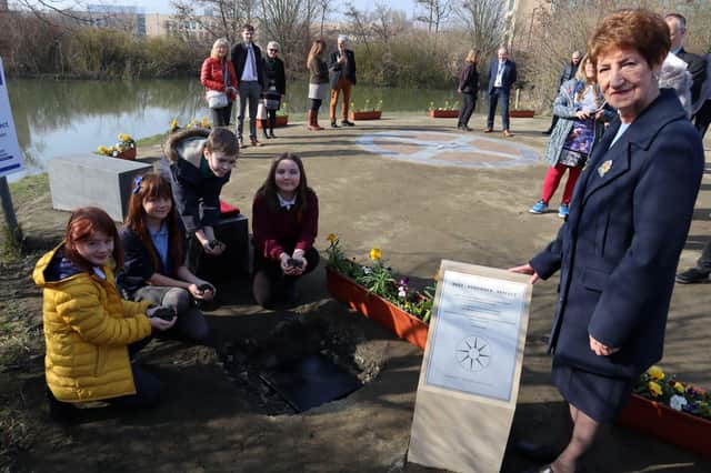 North Tyneside Elected Mayor Norma Redfearn with young carers burying their time capsule.
