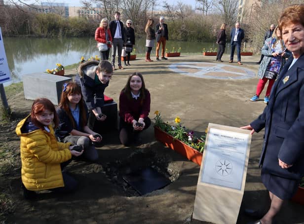 North Tyneside Elected Mayor Norma Redfearn with young carers burying their time capsule.