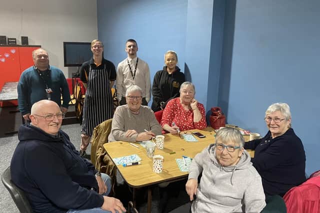 Team members and volunteers from Hadston House with members of the local community at the weekly fun and food evening.