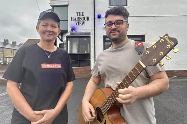 Manager Waseem Mir (right) hired a professional musician for the afternoon, and free t-shirts (as modelled by Nadine Proctor, left) were handed out.