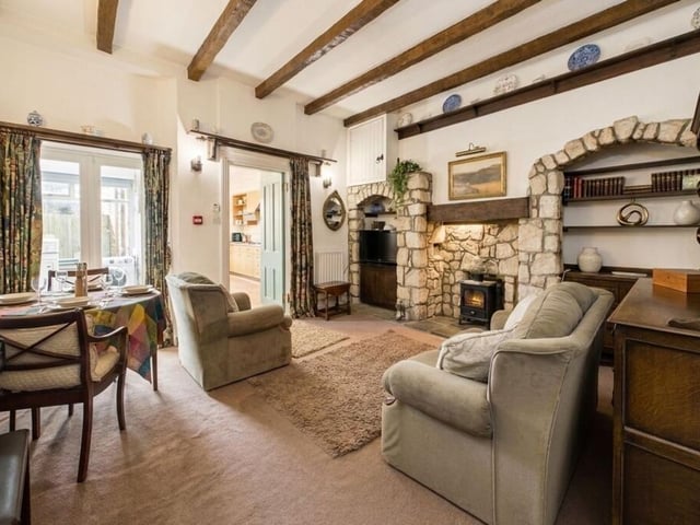 A second sitting room with a stone fireplace.