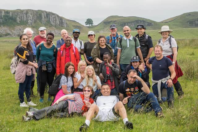 The refugees and asylum seekers, being housed in Newcastle, joined Finnish artist Dr Henna Asikainen and CPRE members for the walk along Hadrian's Wall. They are pictured  at Sycamore Gap.
