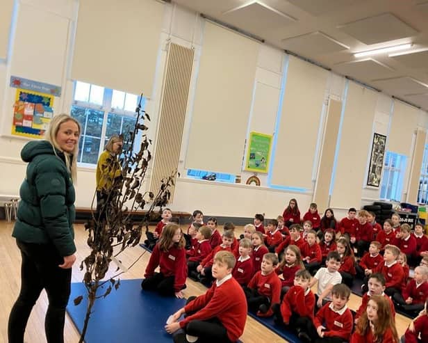 Olivia Leyland, Bedmax, presenting Belford Primary School with a pear tree.