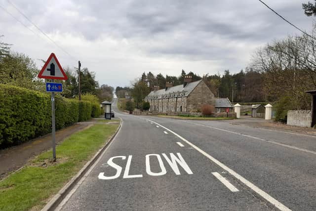 'Slow' signs have been painted on the road at Middleton, near Belford, but parish councillors want to see the speed limit lowered.