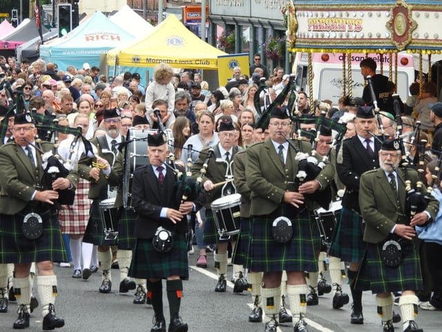 Pipers march through the town centre.