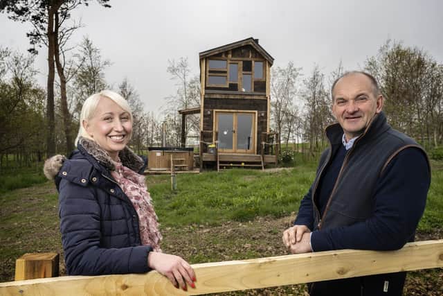 Hillside Huts and Cabins owner Philip Gregory with Robson Laidler director Amy Park outside the new holiday accommodation.