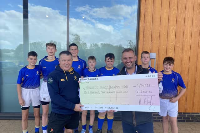 Mark Turnbull presenting a cheque to Alnwick Juniors & Mini Rugby.