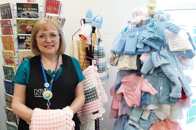 Kathy Nixon with some of the knitted items.
