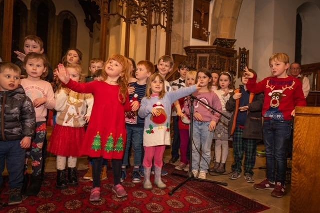 Many of the people gathered in All Saints Church had Christmas jumpers or accessories on.
