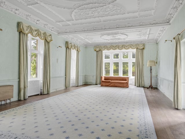 The seven bedroom principal house occupies an elevated setting surrounded by mature woodland and landscaped gardens inspired by the work of Sir Edwin Lutyens.