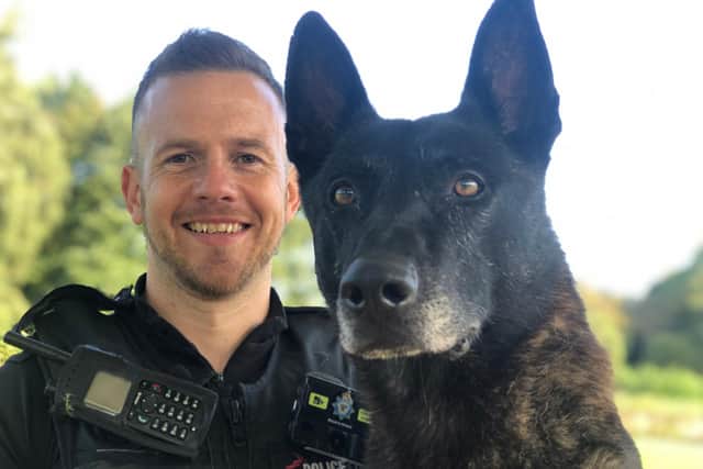 Pc Adam Fegan pictured with police dog Max.