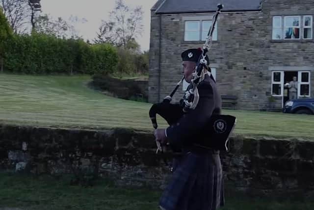 Andy Grant plays the pipes through South Charlton.
