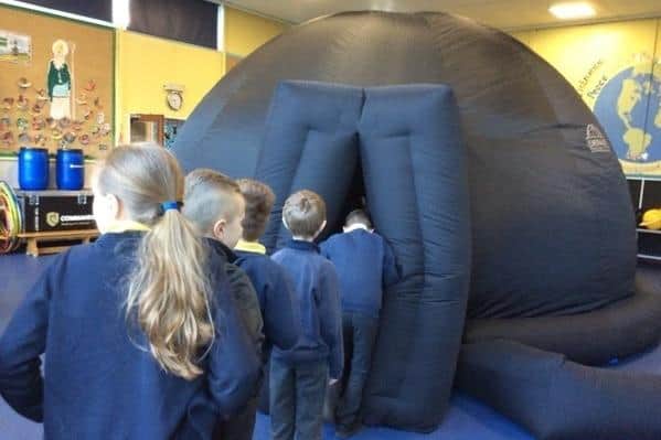 Longhoughton pupils enter the inflatable planetarium.