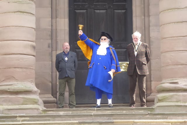 The Town Crier rings the bell to summon townsfolk before reading The Platinum Jubilee Royal Proclamation, accompanied by the Sheriff and Mayor.