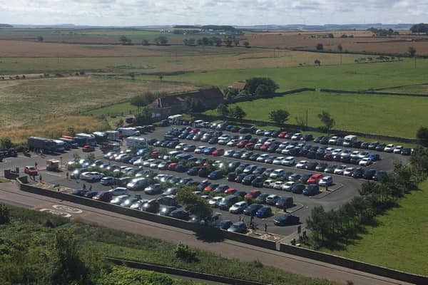 The packed Links Road car park in Bamburgh, viewed from the castle.