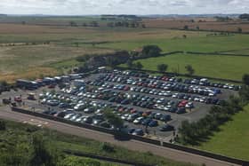 The packed Links Road car park in Bamburgh, viewed from the castle.