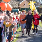 Summer, pictured in the red hoodie, with her classmates on the fun run.