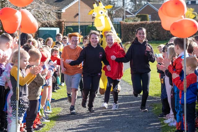 Summer, pictured in the red hoodie, with her classmates on the fun run.