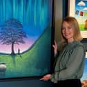 Artist Lucy Pittaway with canvas of her painting of the Sycamore Gap tree. Picture: Dawn Shaefer