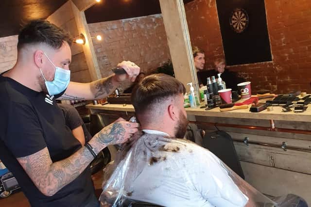Paul Emery at work in Illicit Barbering.