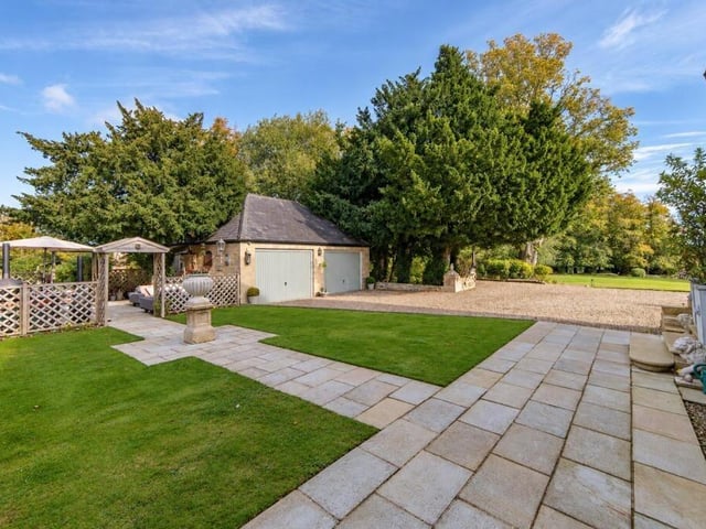 Part of the garden and a detached double garage.