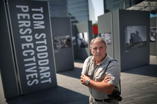 Photographer Tom Stoddart stands at his Perspectives photographic exhibition in London in 2012. Photo by Peter Macdiarmid/Getty Images.