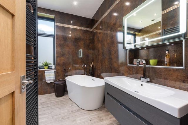 A luxury bathroom with under floor heating.