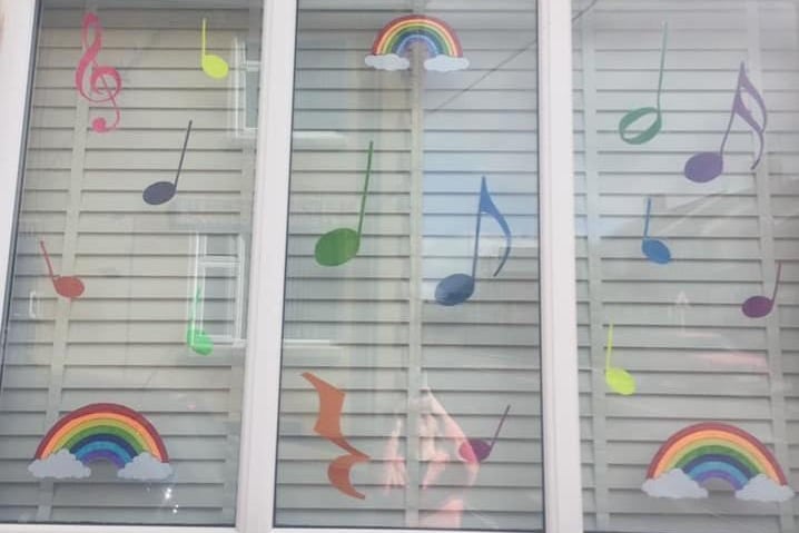 Music teacher Lel Marie decorated her window for people to sing the rainbow song when they see it.
