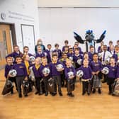 Newcastle United Foundation staff and mascot Monty Magpie deliver Christmas packs and sports equipment to pupils.