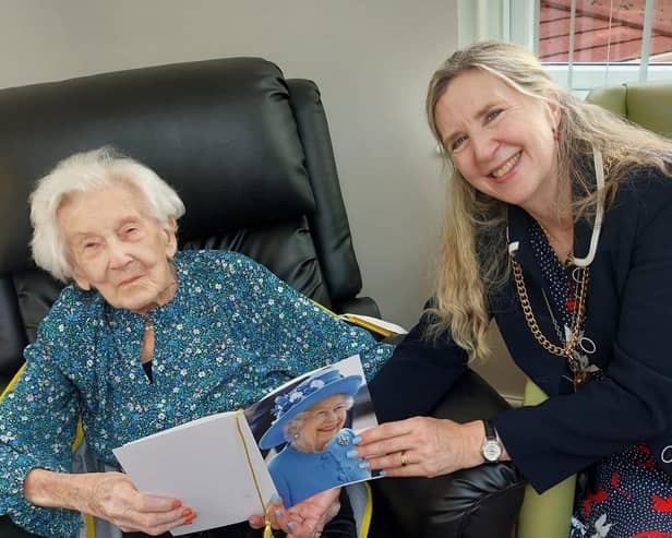Marion Dodds and Coun Alison Byard with the 100th birthday telegram from the late Queen Elizabeth II.