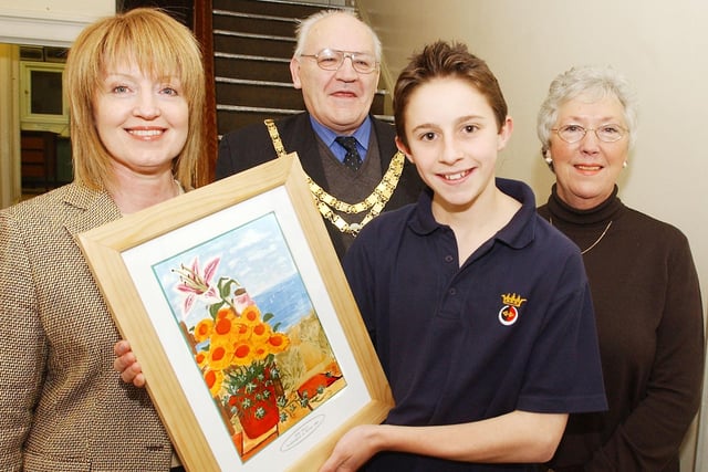 Billy Heyes, a pupil at the Duke's Middle School in Alnwick with a framed copy of his painting selected for Northumbria In Bloom Calendar, seen with headteacher Josie McDonough, Mayor Ken Gray and Ann Turnbull.