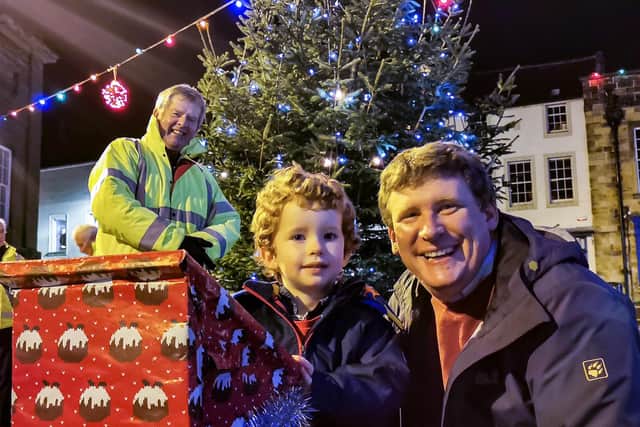 James Abercrombie, with his dad, Richard, switched on Alnwick's Christmas lights, watched by lights committee chairman Gordon Castle.