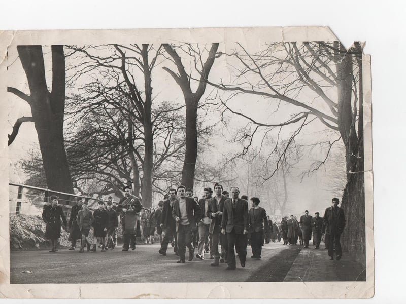 Participants and spectators make their way to the match.