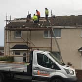 Workers have been spotted carrying out repairs to roofs in the Berwick area today. Picture by Canon Alan Hughes.