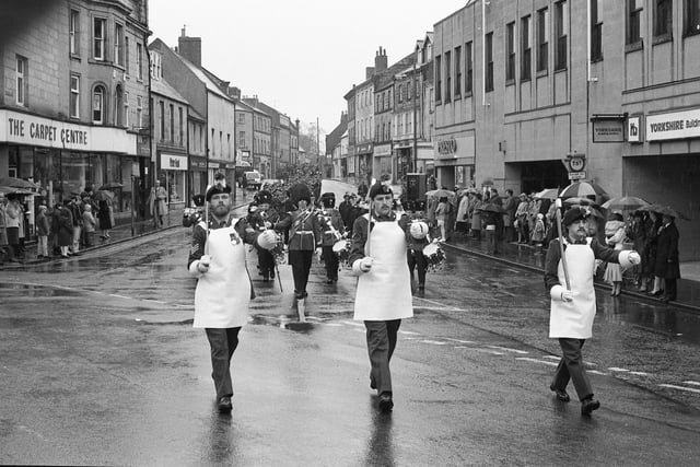 People braved the wet weather to watch the St George's Day parade through Alnwick.