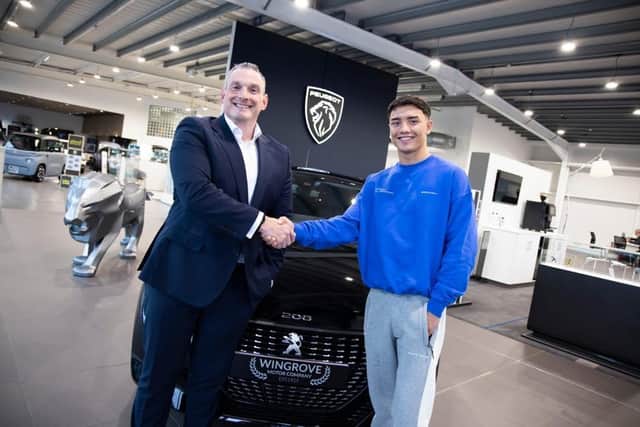 David Guy, group commercial director at Wingrove Motor Company, gives Cameron Vuong the keys to his new car. (Photo by Wingrove Motor Company)